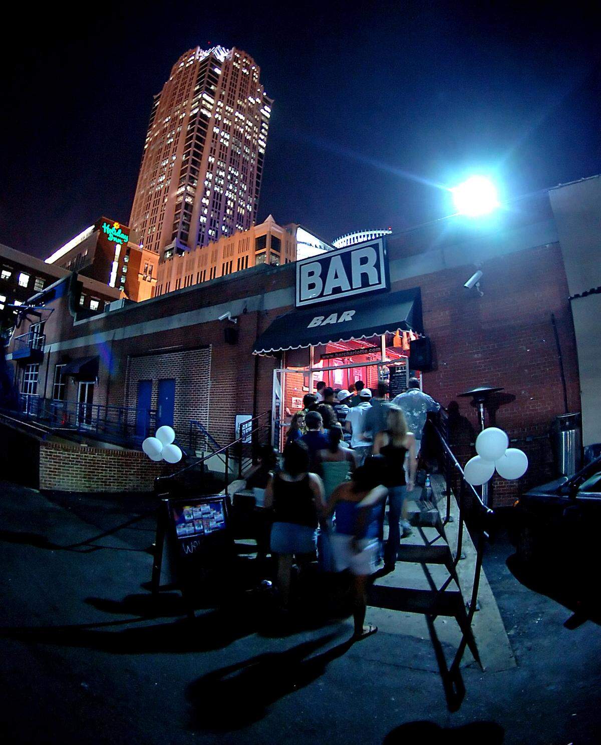 Teens walk up the steps to enter Club 300 in Charlotte on July 31, 2006. On Monday nights, BAR Charlotte became Club 300, a teen’s only bar with no alcohol of cigarettes allowed. The club was opened to youth between the ages of 13 and 18, who roamed the dance floor from 7 p.m. to midnight.