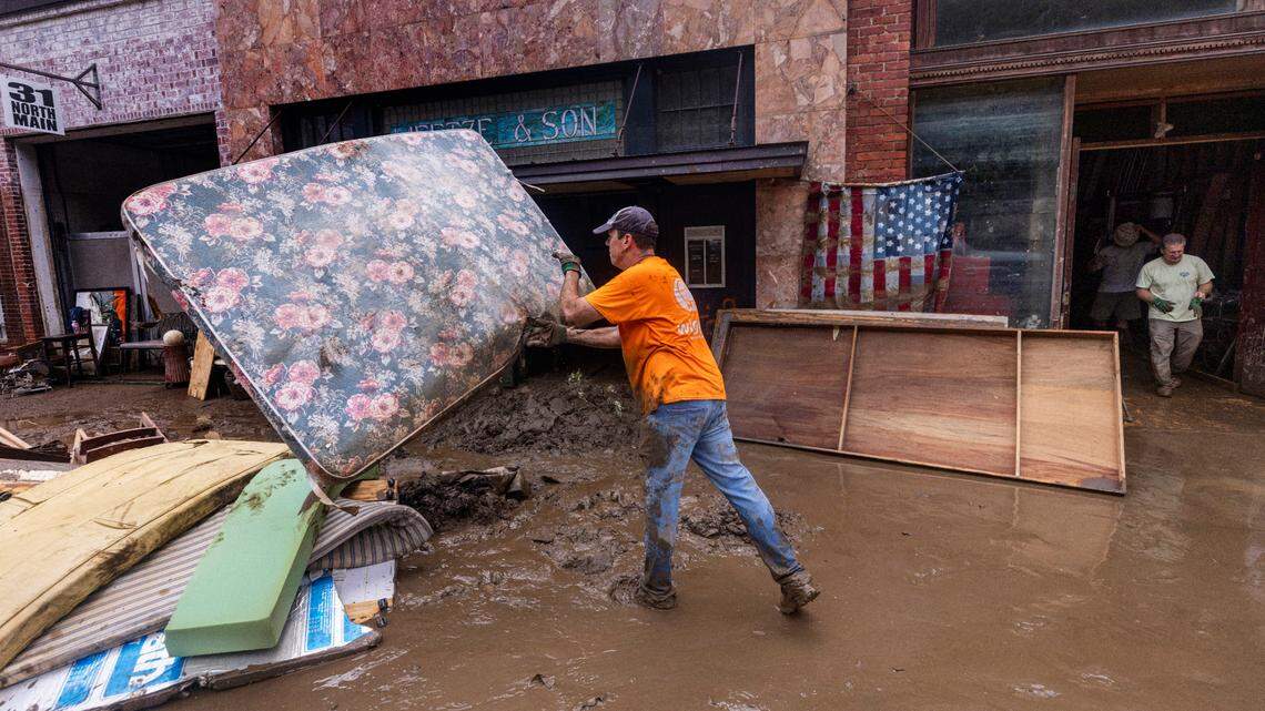 Joe Freeman of Marshall helps clean up downtown on Tuesday, Oct. 1, 2024 after the French Broad River caused catastrophic flooding. The remnants of Hurricane Helene caused widespread flooding, downed trees, and power outages in western North Carolina.