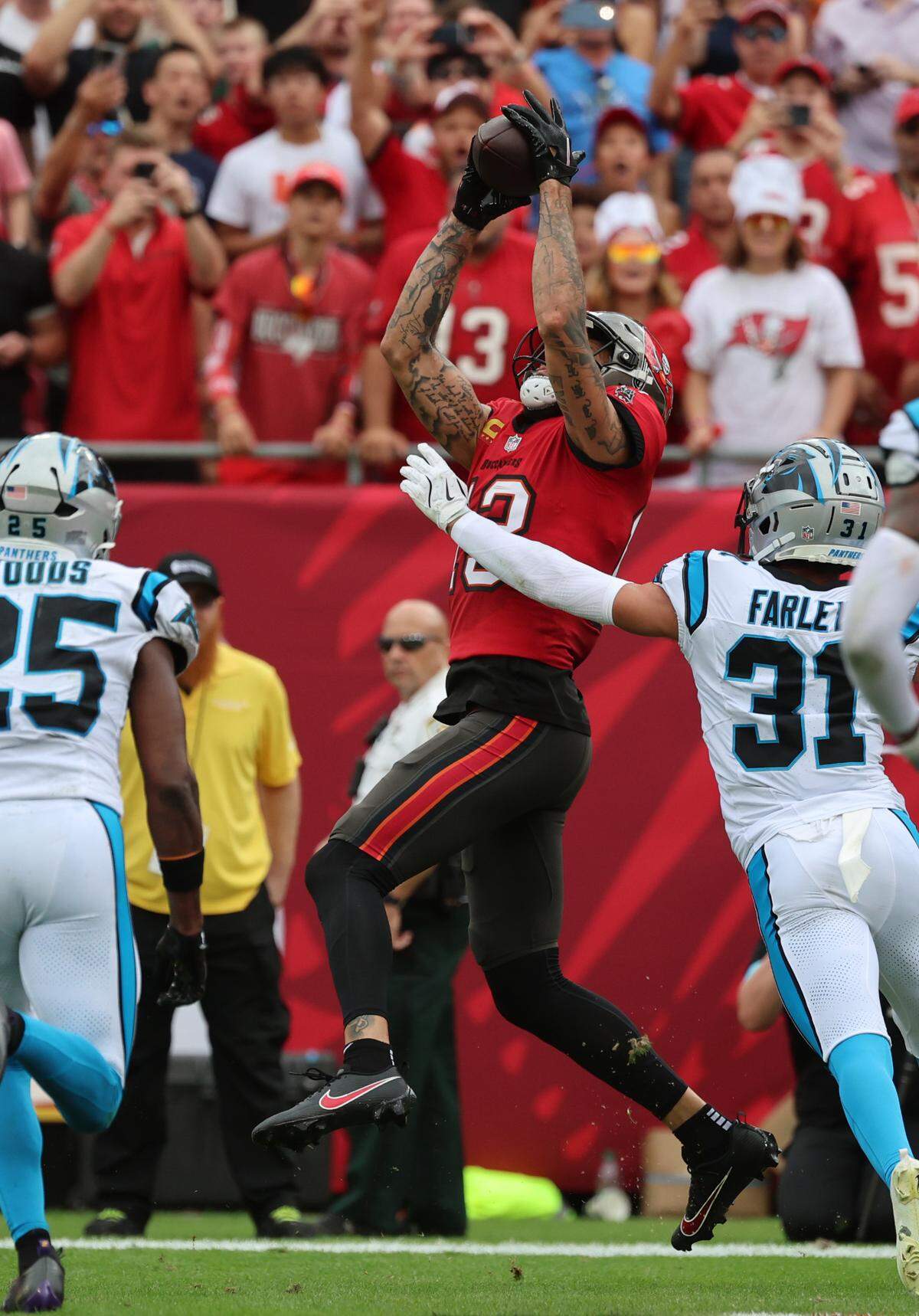 Dec 29, 2024; Tampa, Florida, USA; Tampa Bay Buccaneers wide receiver Mike Evans (13) catches the ball for a touchdown against the Carolina Panthers during the second quarter at Raymond James Stadium. Mandatory Credit: Kim Klement Neitzel-Imagn Images