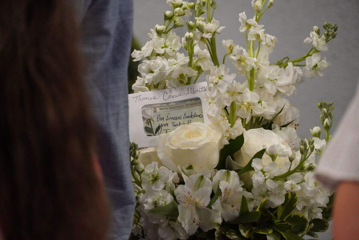 A bundle of flowers with a note of sympathy at Thomas Crowe-Allbritton’s funeral in Durham.
