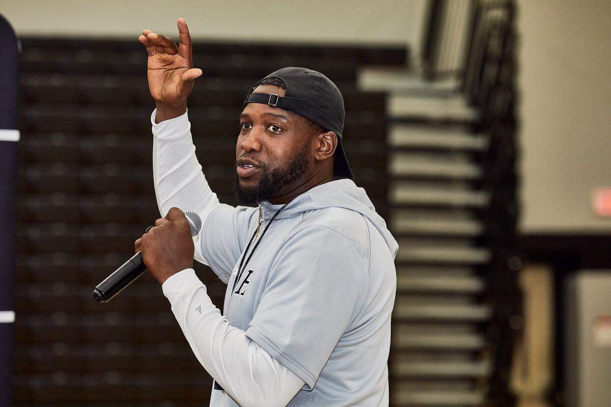 Hough Huskies’ head coach Shawn Baker welcomes in linebacker LJ Porter, a top high school football recruit in North Carolina before his college commitment announcement at Hough High School in Cornelius, NC.