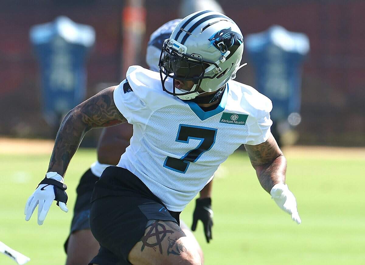 Carolina Panthers safety Tre’von Moehrig glances back as he breaks across the field during a training camp practice in July.