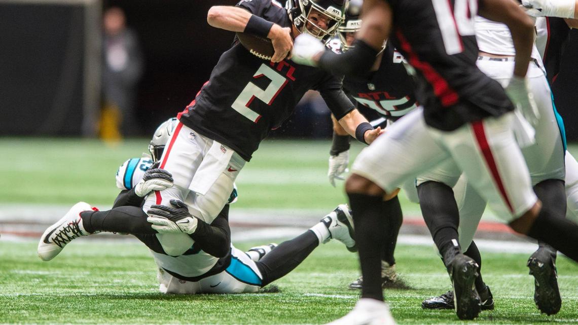 Panthers outside linebacker Haason Reddick, bottom center, sacks Falcons quarterback Matt Ryan, center, during the game at Mercedes-Benz Stadium on Sunday, October 31, 2021 in Atlanta, GA.
