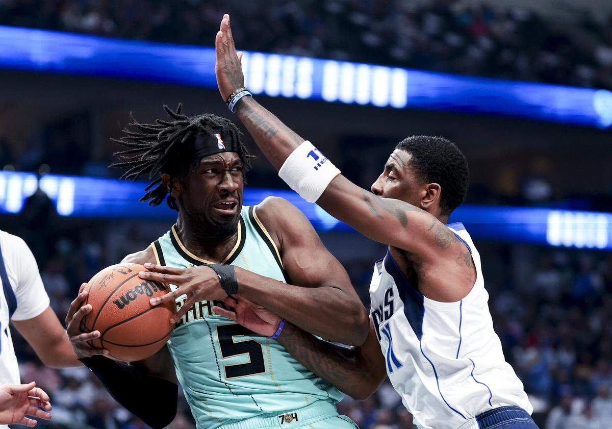Charlotte Hornets center Mark Williams (5) controls the ball as Dallas Mavericks guard Kyrie Irving (11) defends during the first half at American Airlines Center.