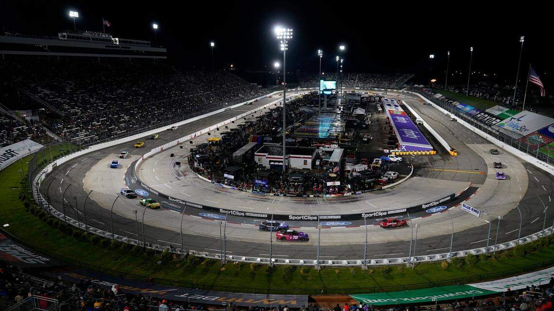 The field drives through Turn 2 during the NASCAR Cup Series auto race at Martinsville Speedway on Saturday, April 9, 2022, in Martinsville, Va. (AP Photo/Steve Helber)
