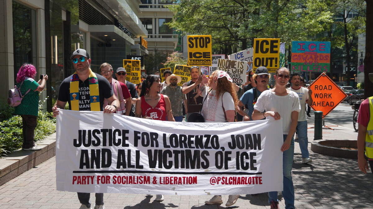 Protesters marching through uptown Charlotte alongside the Party for Socialism and Liberation with the banner “Justice for Lorenzo, Joan and all victims of ICE.”