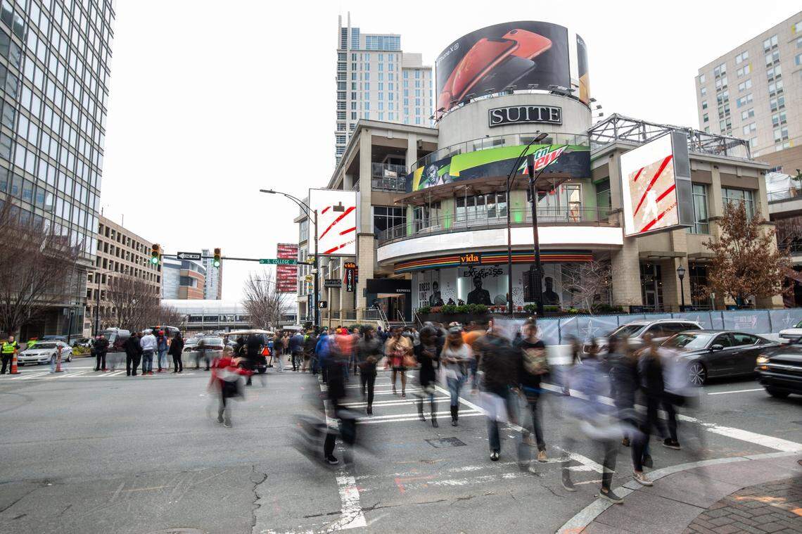 Crowds meander through the light rain Sunday afternoon before the NBA All-Star game in Charlotte in 2019.