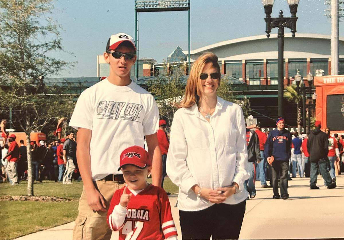 Ryan Fitzgerald, center, attending his first Georgia-Florida college football game at now-named EverBank Stadium in Jacksonville with his parents, Chad and Sandy.