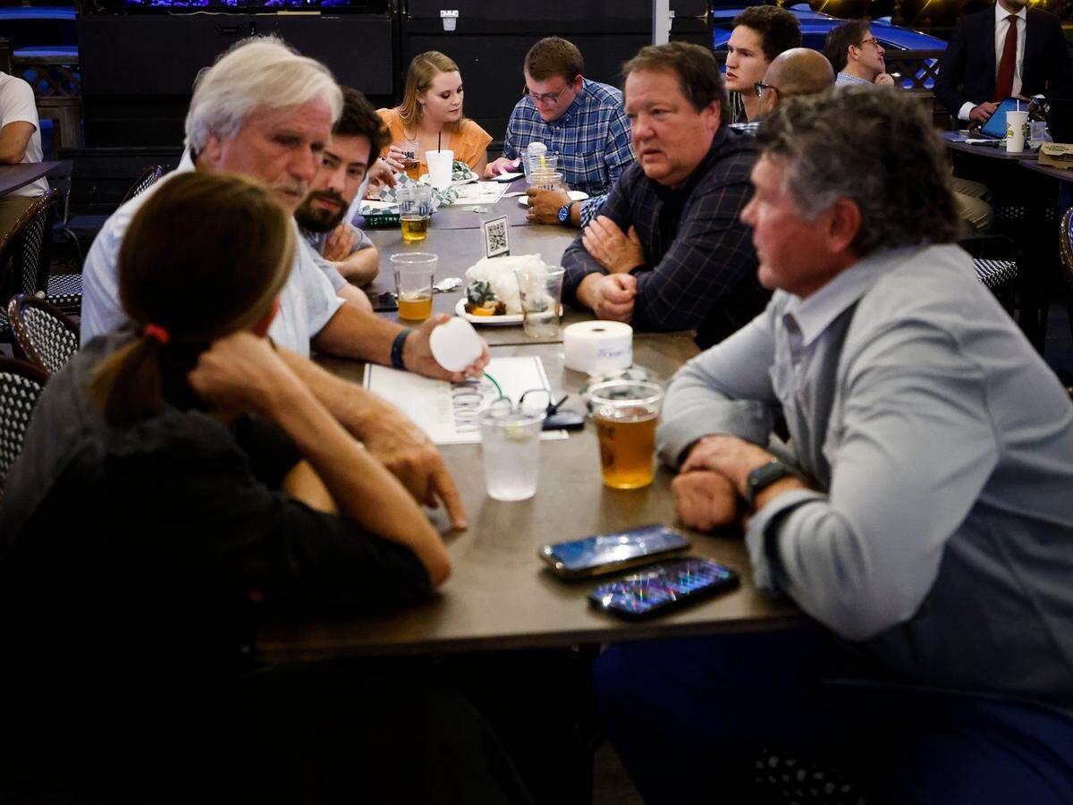 Pat McCrory supporters Camryn Riddle, of Charlotte, N.C., center left, and Lucas Snyder, of Winston-Salem, N.C., center right, wait for the former mayor and North Carolina governor to arrive at Selwyn Pub in Charlotte, Tuesday, May 17, 2022. McCrory lost the Republican primary race for U.S. Senate.