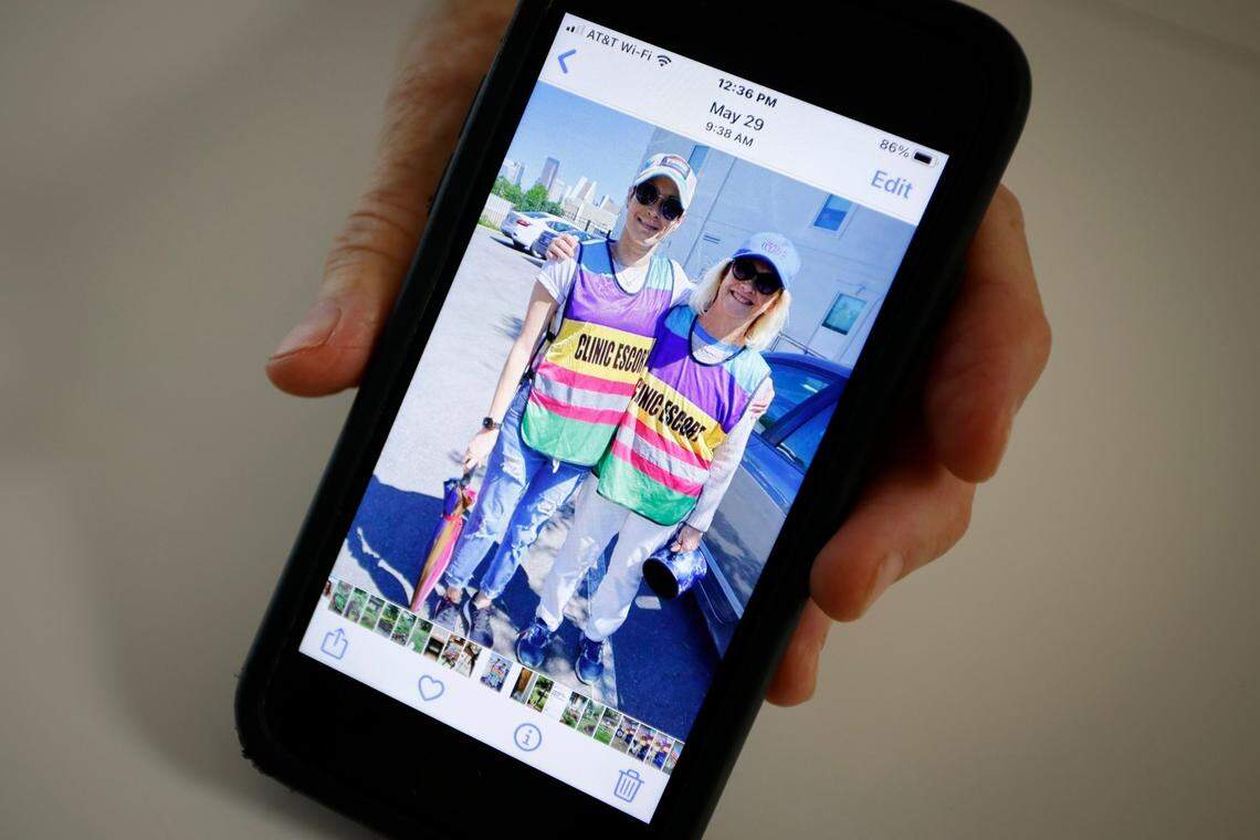 Abortion rights advocate Diane Stevens of Waxhaw shows a picture of herself with her daughter as clinic escorts for Planned Parenthood.