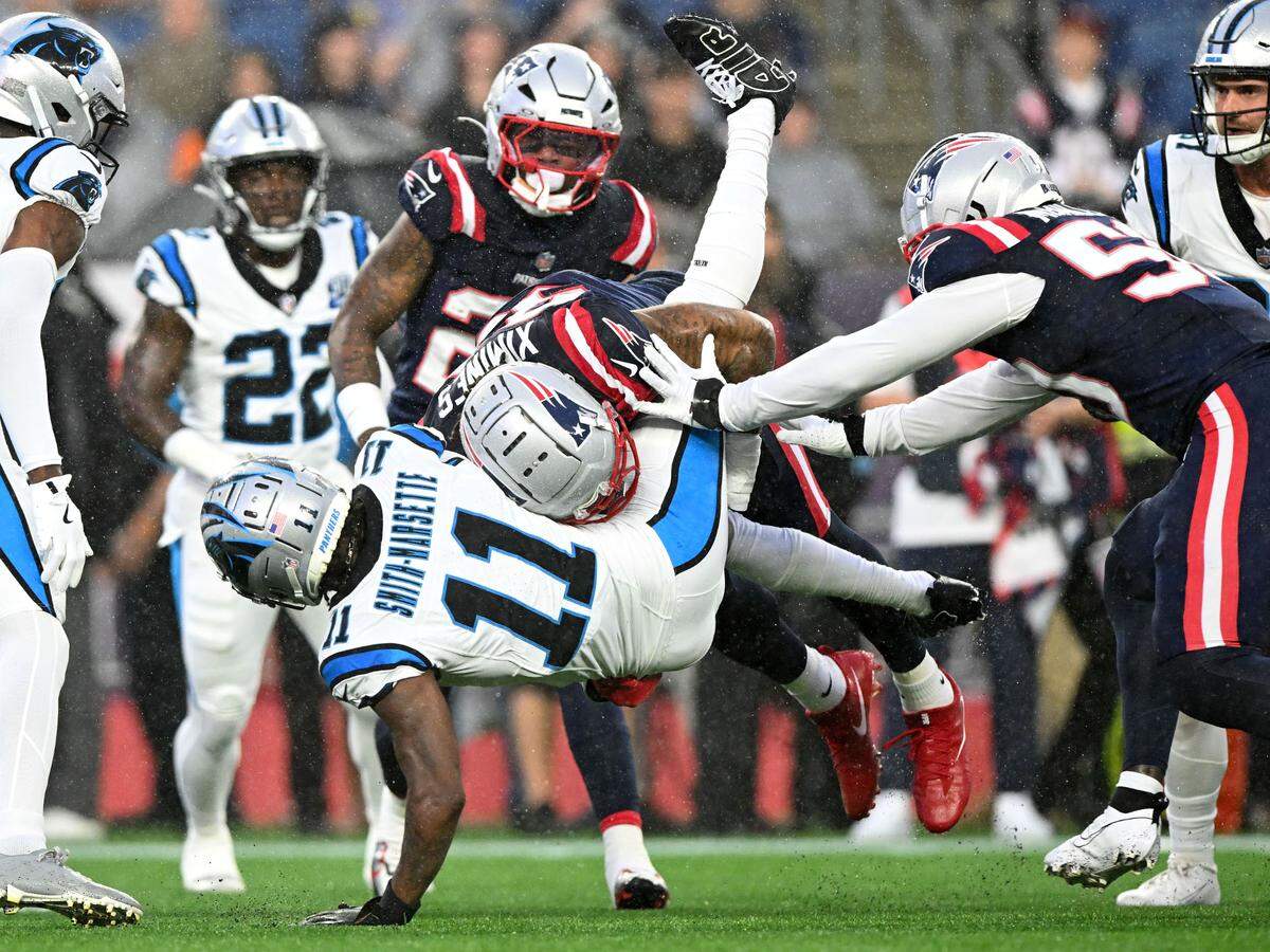 New England Patriots linebacker Oshane Ximines (93) tackles Carolina Panthers wide receiver Ihmir Smith-Marsette (11) during the first half at Gillette Stadium. Brian Fluharty-USA TODAY Sports