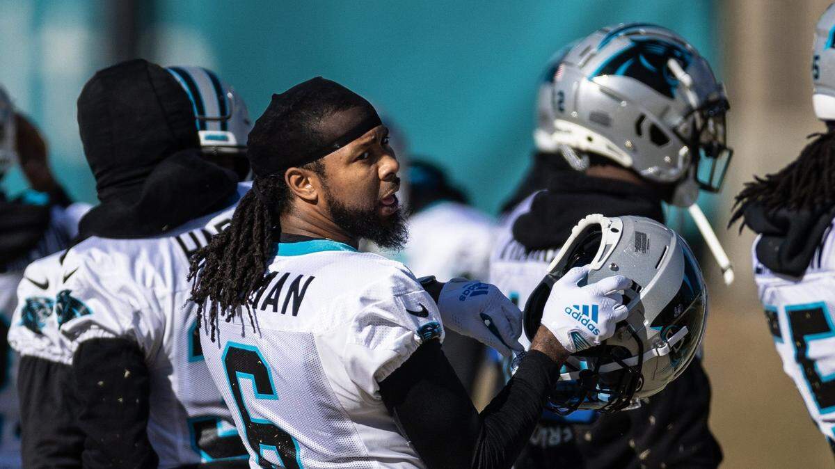 Carolina Panthers cornerback Josh Norman puts his helmet on at practice in Charlotte, N.C., on Wednesday, December 28, 2022. Norman, 35, rejoined his old team this week and may play in a limited role Sunday.