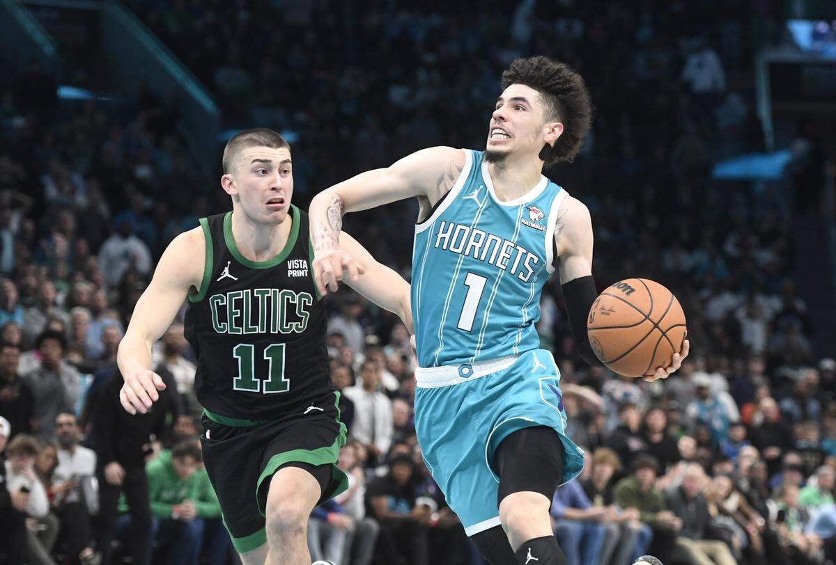 Charlotte Hornets guard LaMelo Ball (1) drives past Boston Celtics guard Payton Pritchard (11) during the second half at the Spectrum Center.