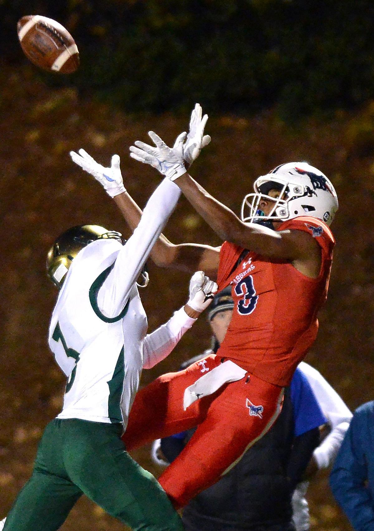 Providence Day Chargers wide receiver Jordan Shipp, right, attempts to catch a deep pass as Rabun Gap cornerback Lucas Pacheco, left applies defensive pressure during second quarter action at Providence Day School in Charlotte, NC on Friday, November 19, 2021. The Chargers hosted Rabun Gap in the NCISAA boys state championship game.