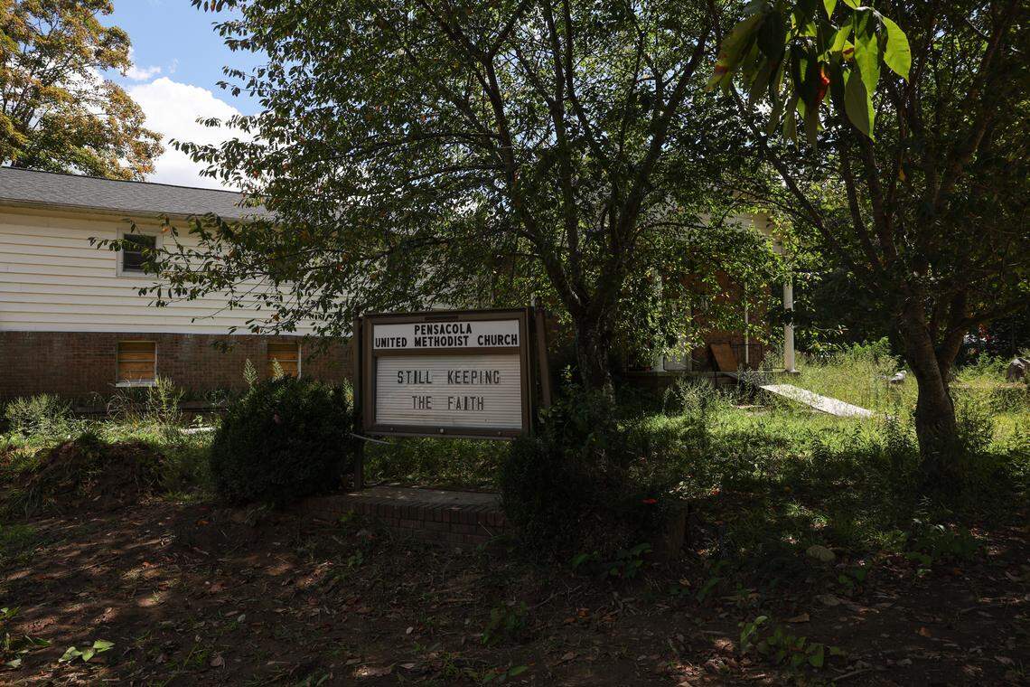 A sign next to Pensacola United Methodist Church says “Still Keeping The Faith” as the town continues to try and recover after Hurricane Helene rolled through the region last year.