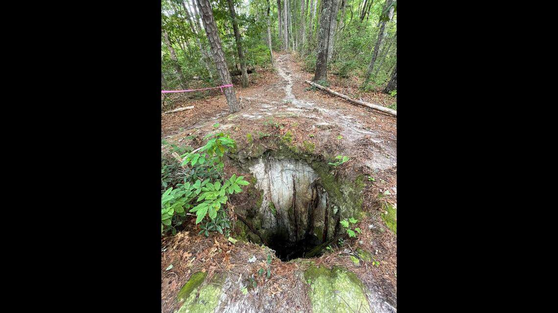Known as the “sinkhole,” the 6-foot wide, 30-foot-deep mine shaft is conspicuously located on a popular biking trail in Pisgah National Forest in North Carolina.