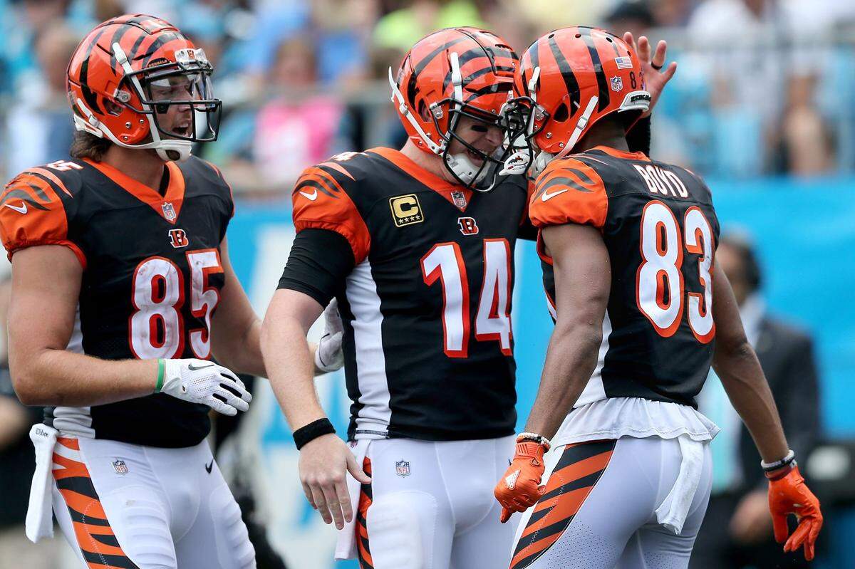 Cincinnati Bengals quarterback Andy Dalton (14), center, and Cincinnati Bengals tight end Tyler Eifert (85), left, congratulate Cincinnati Bengals wide receiver Tyler Boyd (83) on his touchdown catch in the third quarter during a Week 3 NFL game between the Cincinnati Bengals and the Carolina Panthers, Sunday, Sept. 23, 2018, at Bank of America Stadium in Charlotte, North Carolina. Carolina won 31-21. Cincinnati Bengals vs. Carolina Panthers, Sept. 23, Week 3