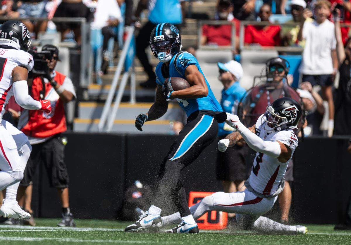 Carolina Panthers wide receiver Tetairoa McMillan, left, is pulled down by Atlanta Falcons free safety Jessie Bates on Sunday at Bank of America Stadium in Charlotte on Sunday, Sept. 21, 2025