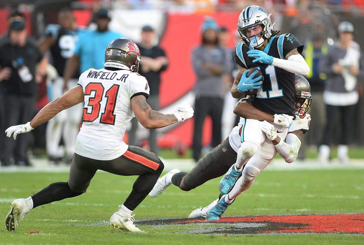 Carolina Panthers wide receiver Robby Anderson, right, fights for yardage following a pass reception during second quarter action against the Tampa Bay Buccaneers at Raymond James Stadium in Tampa, Fl. on Sunday, January 9, 2022.