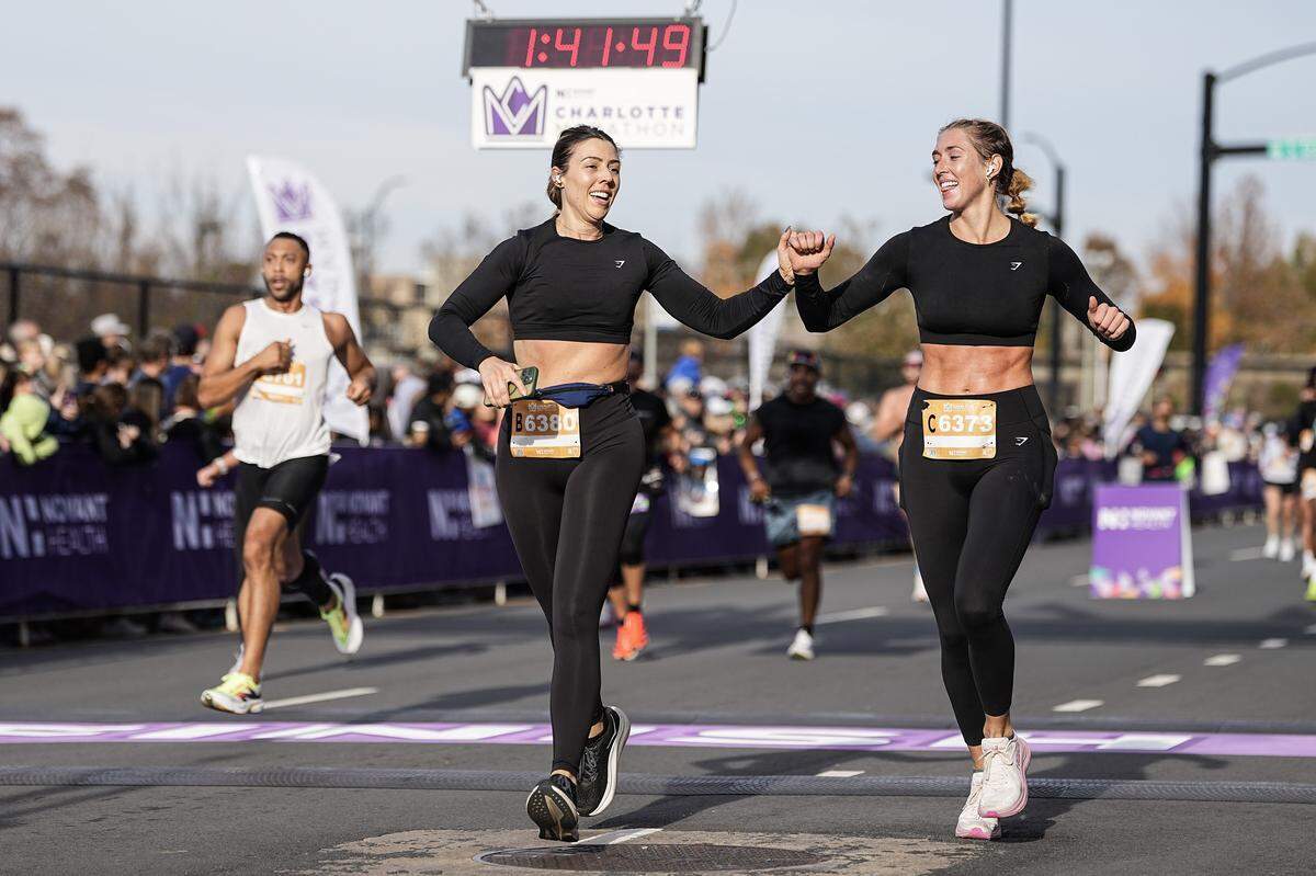 Participants celebrate after competing in the Novant Health Charlotte Marathon Saturday, Nov. 15, 2025, in Charlotte, N.C.