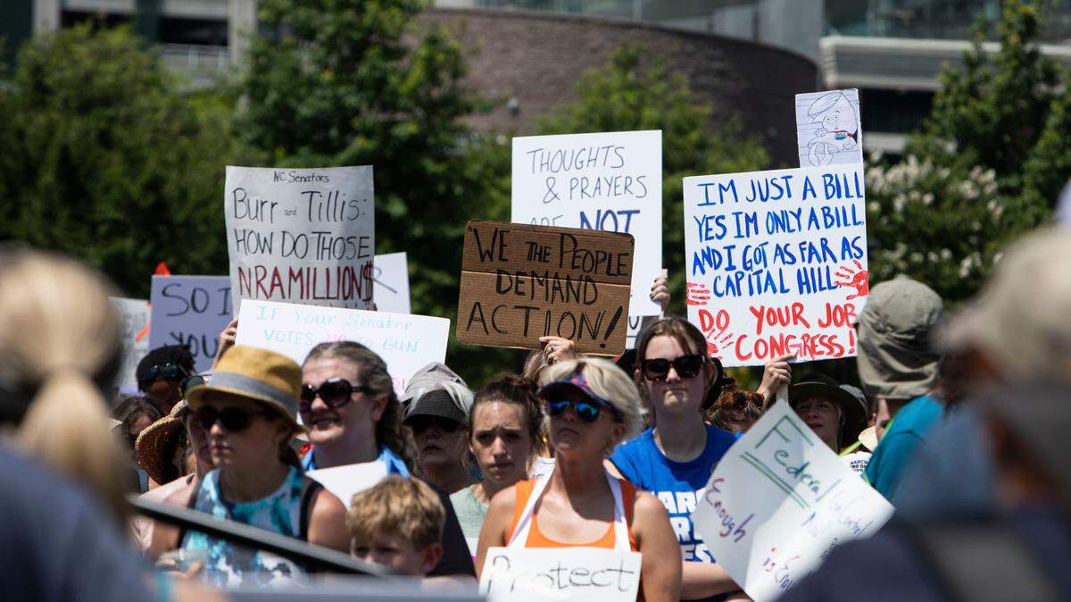 Hundreds of people gathered at First Ward Park in Charlotte on June 12, 2022 for a March for Our Lives protest. They carried signs calling for protection for children against gun violence.
