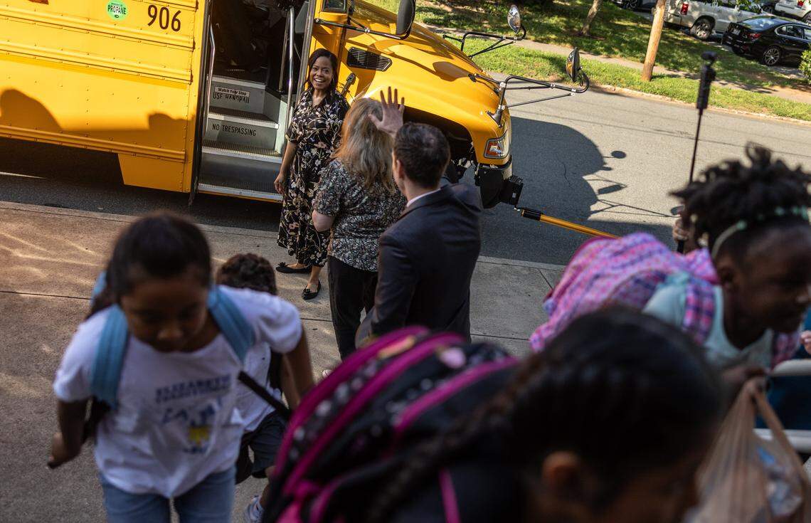 CMS Superintendent Dr. Crystal Hill arrives with a bus of students during the first day of school at Elizabeth Traditional School in Charlotte, N.C., on Monday, August 25, 2025.