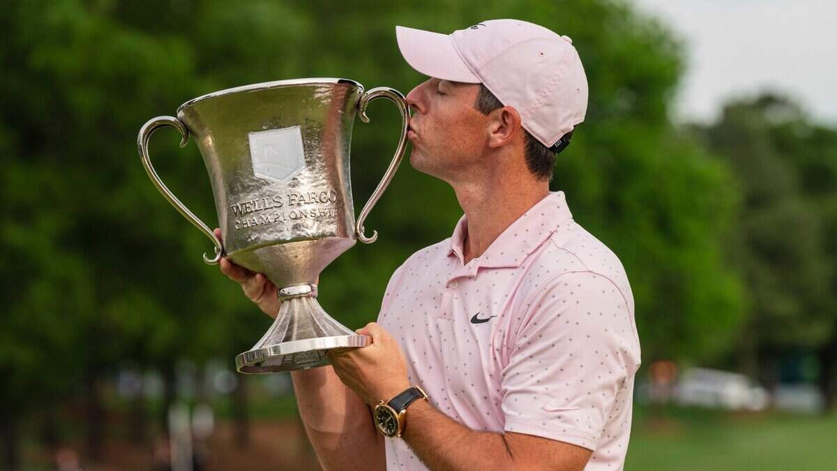 Rory McIlroy kisses the trophy after winning the Wells Fargo Championship golf tournament at Quail Hollow on Sunday, May 9, 2021, in Charlotte, N.C. (AP Photo/Jacob Kupferman)