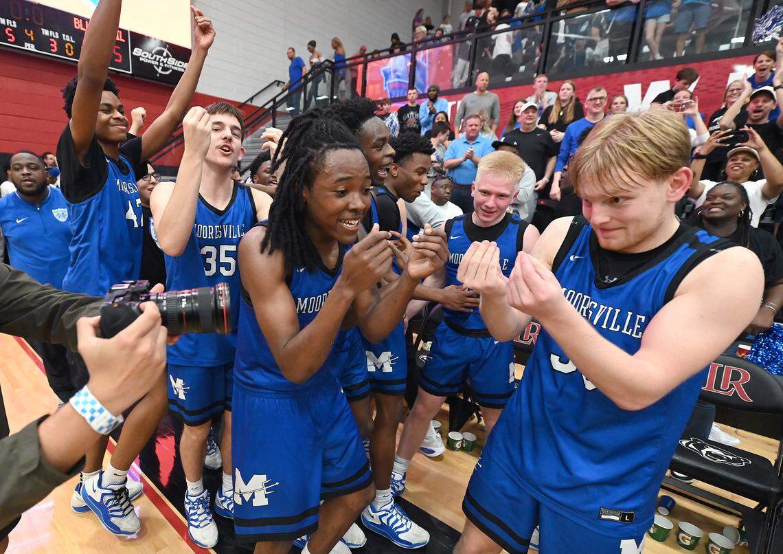 Members of the Mooresville basketball team celebrate their 55-52 win over North Meck in the boy’s 7A NCHSAA regional championship game at Lenoir-Rhyne University in Hickory, NC on Friday, March 6, 2026.