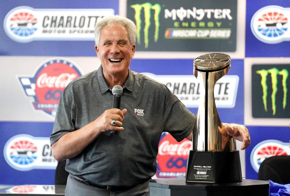 Former NASCAR driver Darrell Waltrip clutches the Bruton Smith Trophy he received Thursday at Charlotte Motor Speedway for being the winningest Coca-Cola 600 driver. Waltrip, who is retiring as a Fox Sports analyst after this season, won the race five times during his Hall of Fame career.