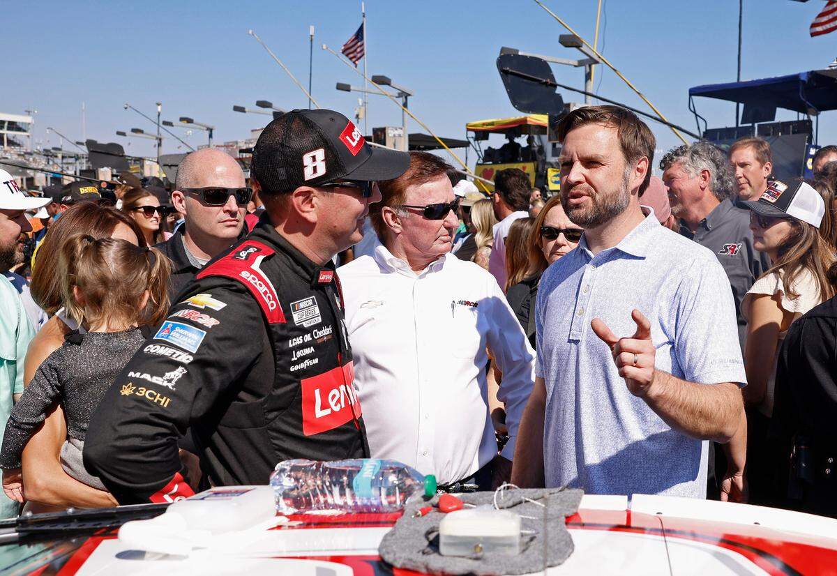 Vice Presidential Nominee Senator JD Vance, right, speaks with NASCAR driver Kyle Busch, left and team owner Richard Childress, center, on pit road at Charlotte Motor Speedway prior to the running of the Bank of America Roval 400 on Sunday, October 13, 2024 in Concord, NC.