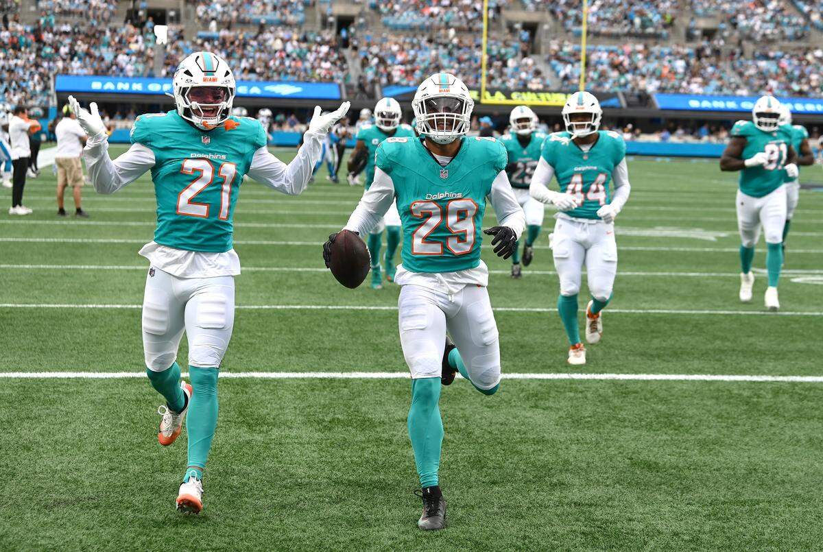 Miami Dolphins safety Minkah Fitzpatrick, center, runs into the end zone to celebrate his interception of a pass by Carolina Panthers quarterback Bryce Young during action on Sunday, October 5, 2025 at Bank of America Stadium in Charlotte, NC.