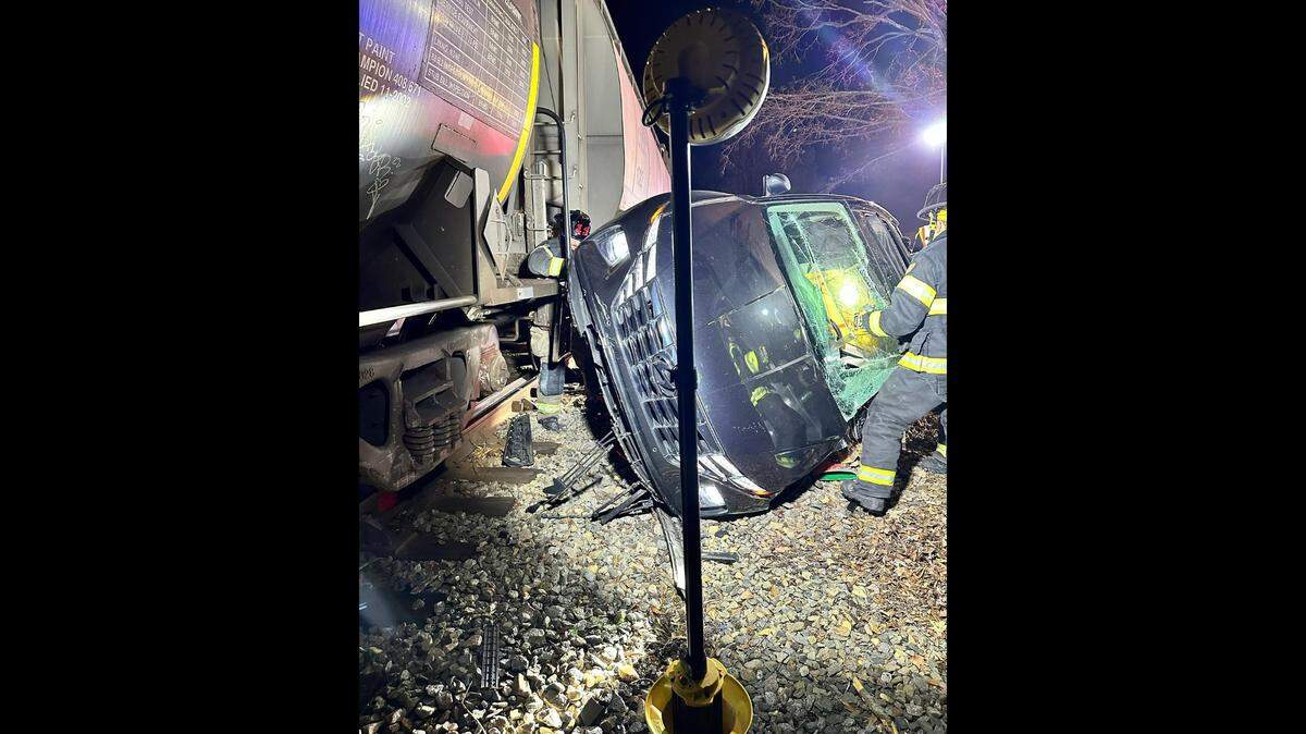 An SUV collided with a moving train in Matthews, leaving two seriously injured people trapped inside, according to Matthews Fire & EMS.