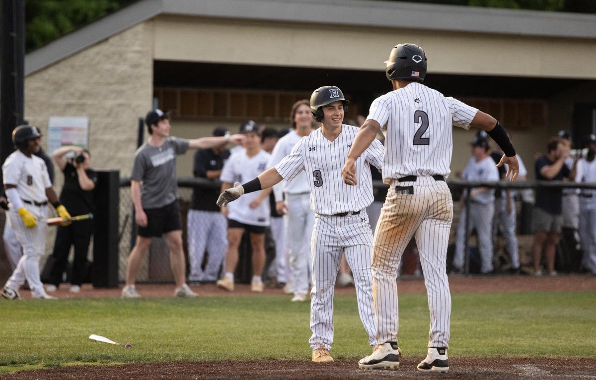 Hough Huskies Jaxon Keeling, right, and Thomas Bass celebrate a run against the Hopewell Titans William Amos Hough High School in Cornelius, N.C., on Wednesday, April 30, 2025.