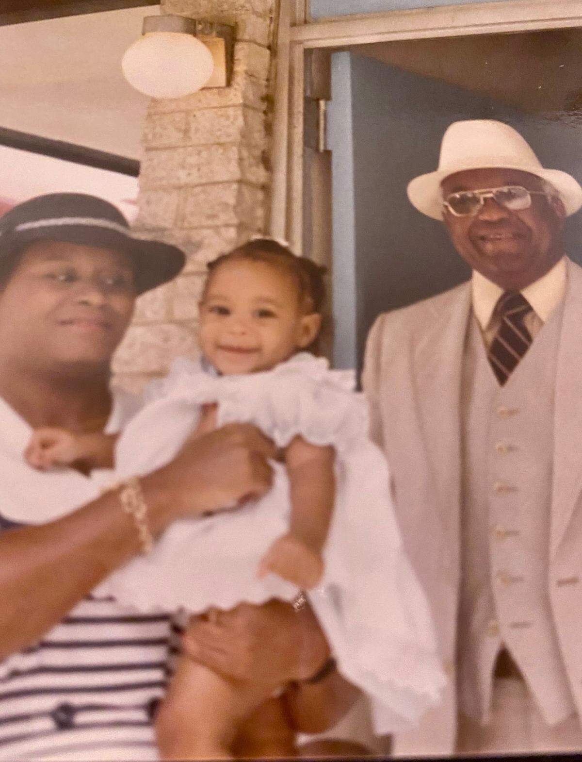 Diane Taylor holds her daughter, DeAnna Taylor, next to DeAnna’s grandfather, Everett Taylor Sr., in this undated file photo. Reporter DeAnna Taylor interviewed her grandfather about what it was like growing up in Charlotte.