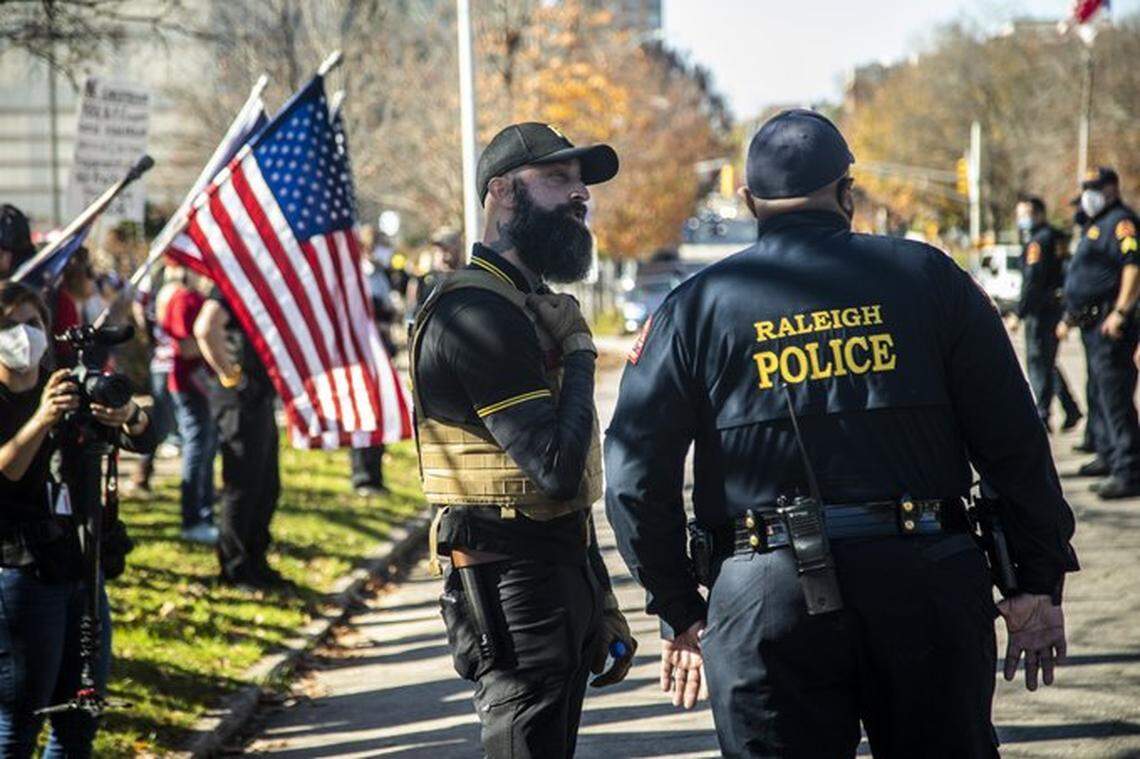 Jeremy Bertino of Belmont talks with a Raleigh Police officer during a rally in support of former President Donald Trump in downtown Raleigh Saturday, Nov. 28, 2020. Bertino, 43, a leader of the Proud Boys, a militant right wing group, becomes the second North Carolinian to plead guilty conspiracy to use force to oppose the government of the United States.