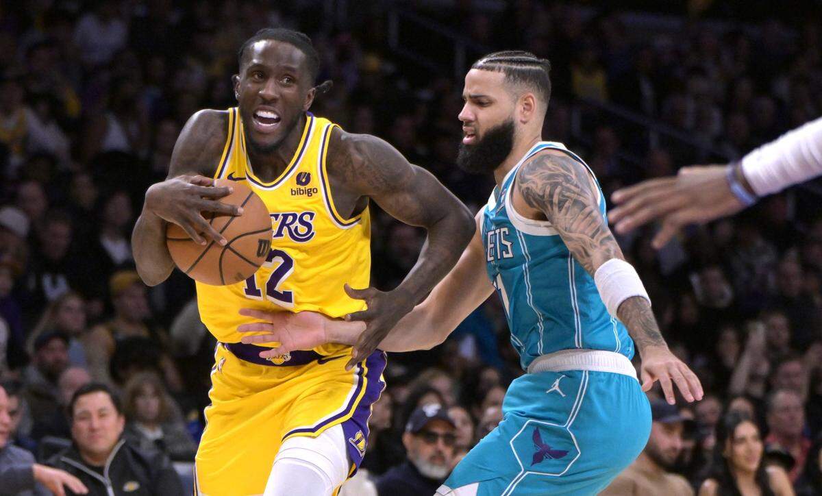 Los Angeles Lakers forward Taurean Prince (12) is defended by Charlotte Hornets forward Cody Martin (11) in the first half at Crypto.com Arena. Mandatory Credit: