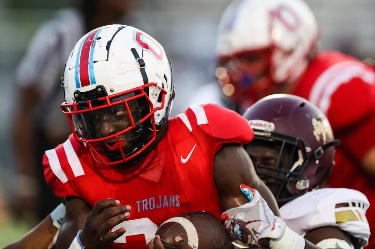 Olympic’s running back Devin Walker drags Harding’s defense on a run during the game on Friday, September 16, 2022 in Charlotte, NC.