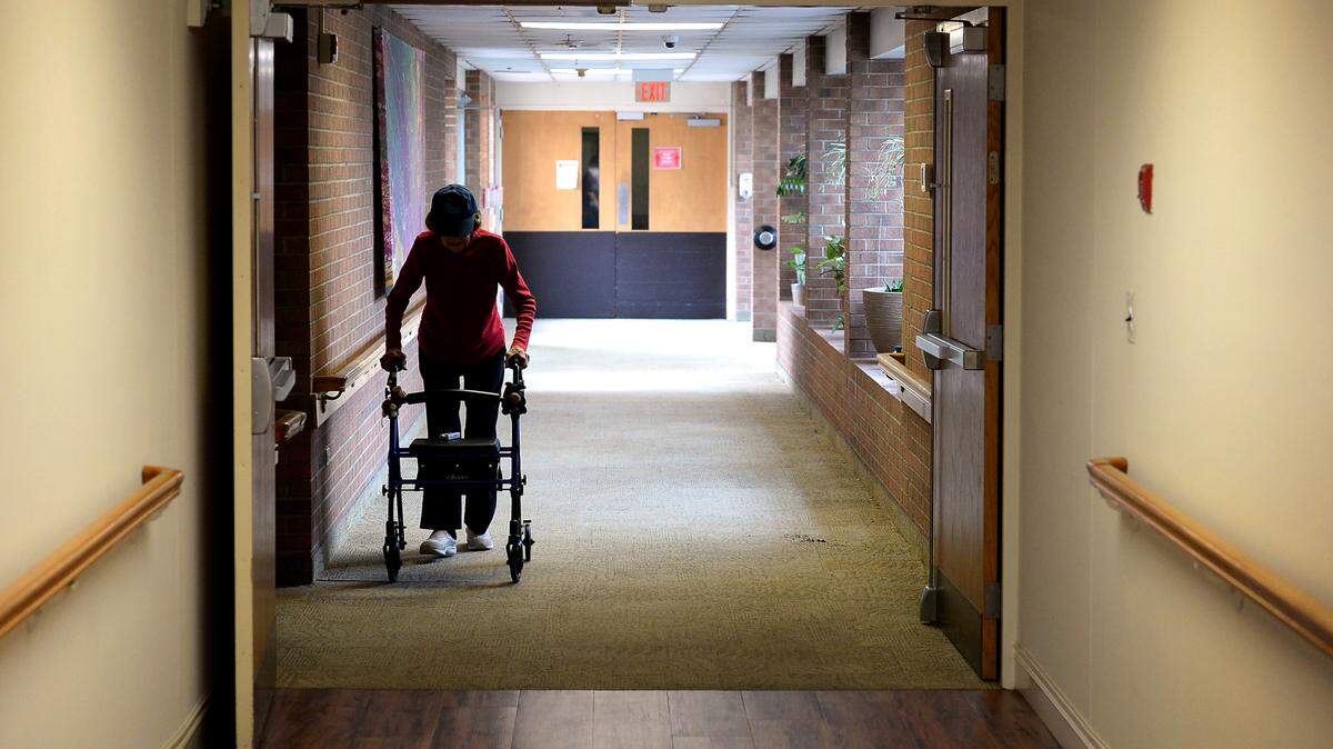 A resident at a Salisbury nursing home makes her way down a hallway. Most states require minimum staffing ratios for nursing homes. North Carolina isn’t among them.