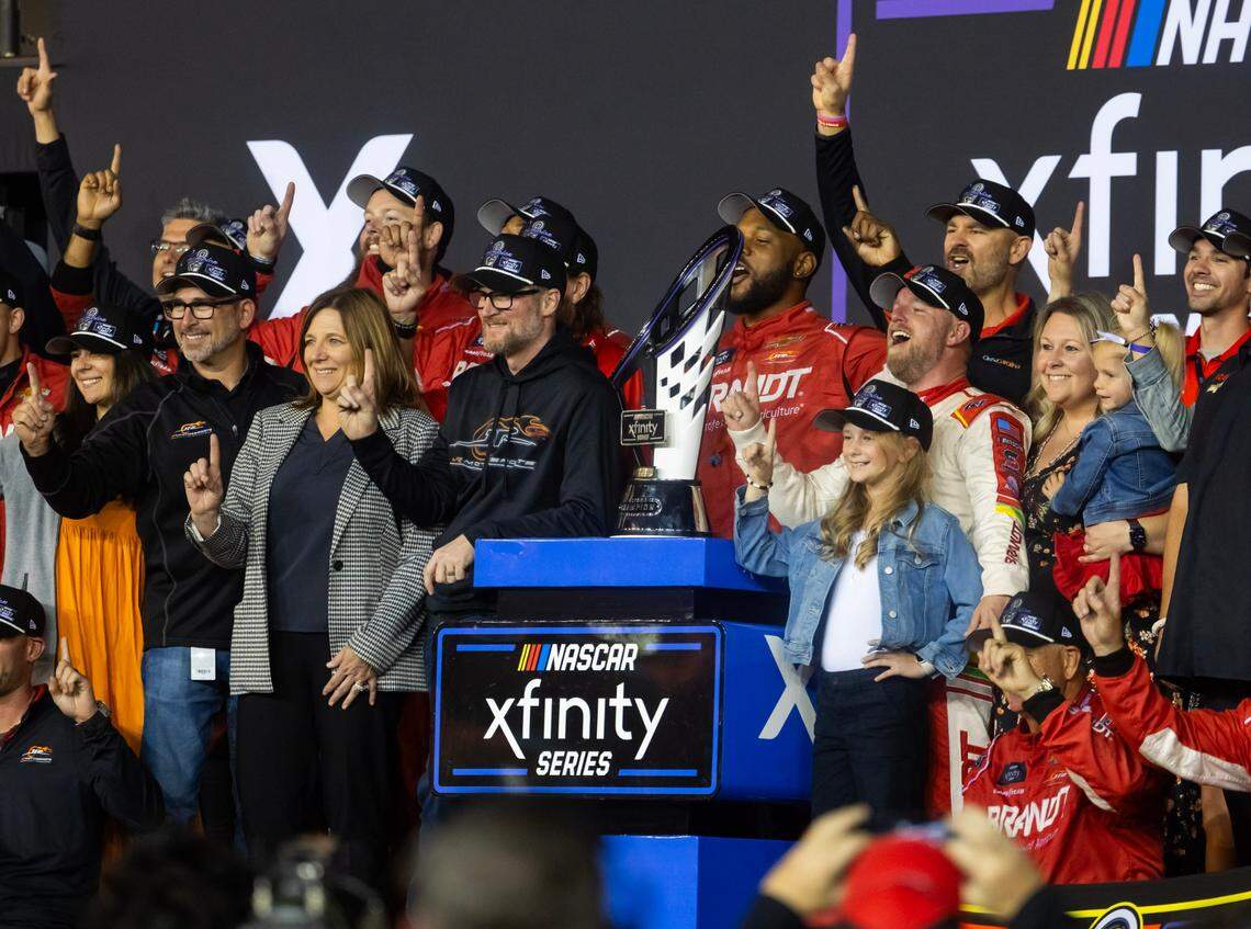 Nov 9, 2024; Avondale, Arizona, USA; NASCAR Xfinity Series team owner Dale Earnhardt Jr and sister Kelley Earnhardt Miller celebrate with driver Justin Allgaier after winning the 2024 Xfinity Series championship during the Championship race at Phoenix Raceway.