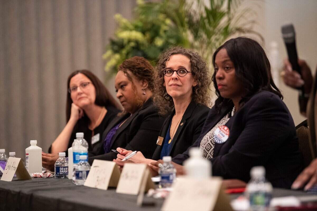Leigh Altman, second from right, listens during the Black Political Caucus’ forum for county commissioner candidates at C N Jenkins Memorial Presbyterian Church on Thursday, March 31, 2022 in Charlotte.