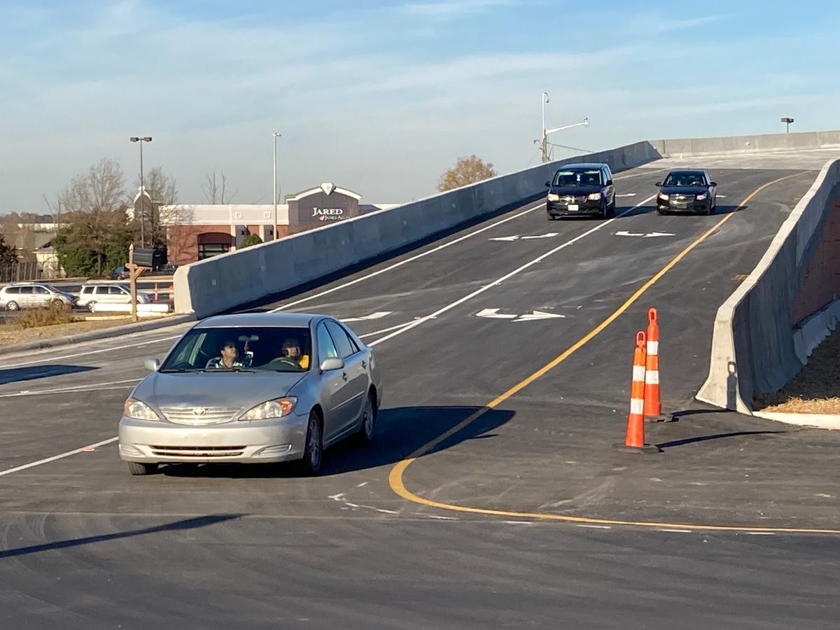 Vehicles come off the new flyover bridge at Concord Mills in Concord, NC, on Wednesday, Nov. 24, 2021. The bridge begins on Concord Mills Boulevard and ends in the parking area. It’s meant to ease longstanding traffic problems, especially during the holiday shopping season.