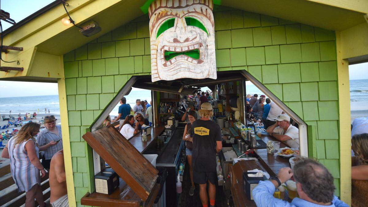 Crowds gathered on a busy night at the Ocean Grill and Tiki Bar in Carolina Beach, N.C. The bar sits on a pier overlooking the Atlantic Ocean.