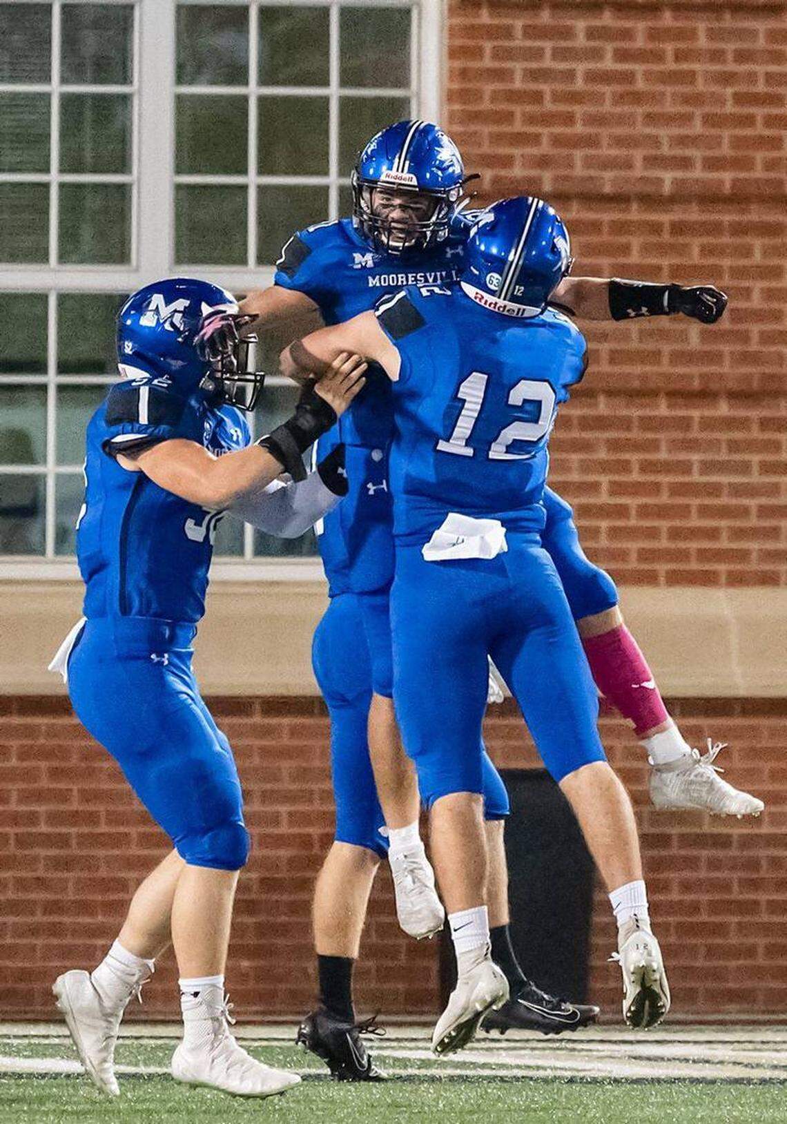 Mooresville High football players celebrate a touchdown