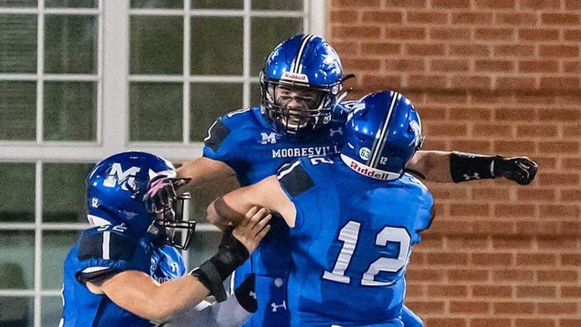 Mooresville High football players celebrate a touchdown