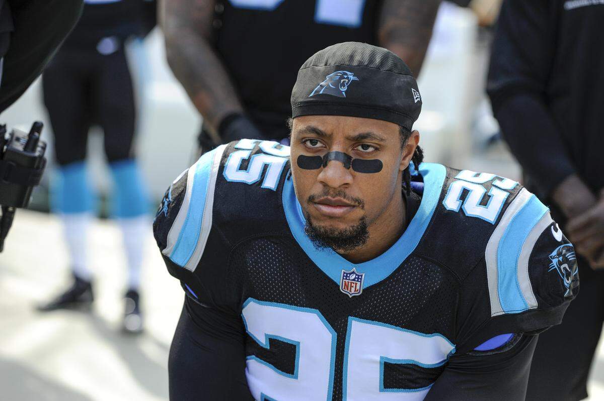 Carolina Panthers strong safety Eric Reid (25) knells along the sideline during the National Anthem before the start of an NFL football game against the Seattle Seahawks in Charlotte, N.C., Sunday, Nov. 25, 2018. (AP Photo/Mike McCarn)