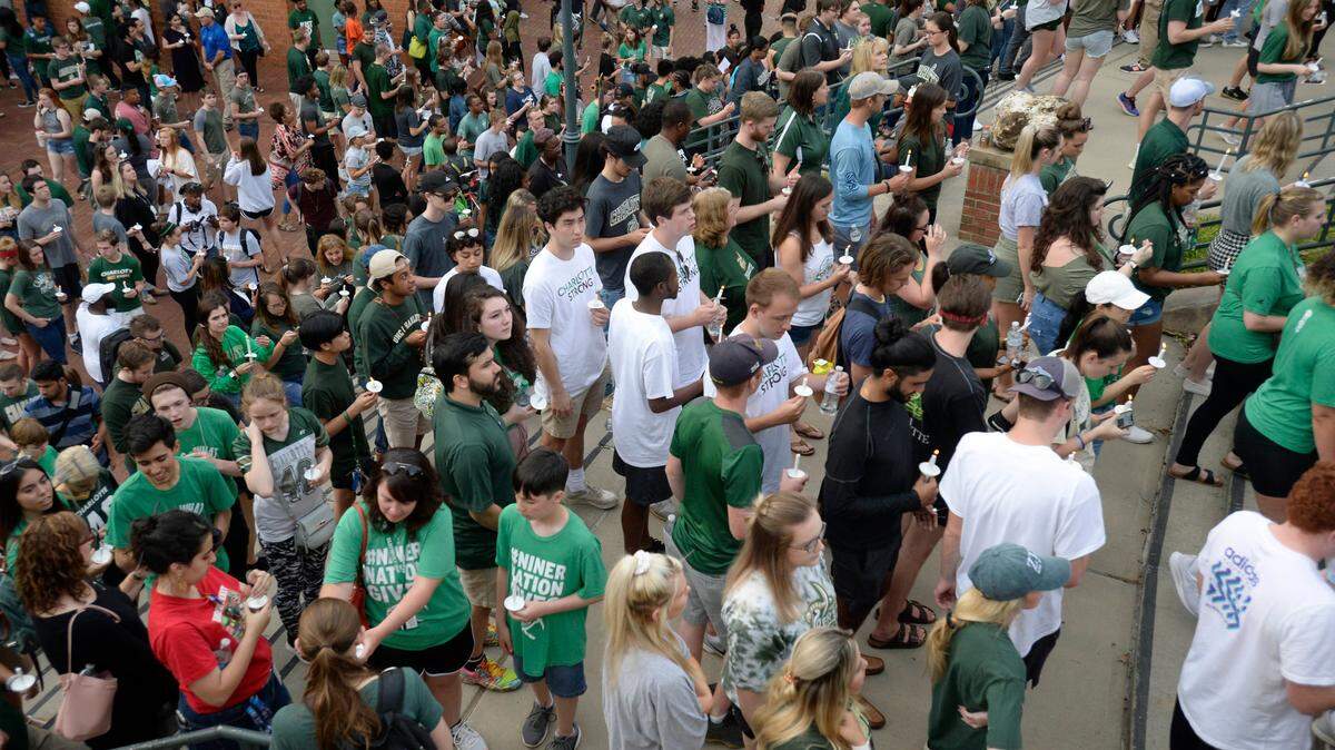 UNC Charlotte students light candles and assemble near Halton Arena during a vigil on Wednesday, May 1, 2019 in memory of the students killed during a campus shooting on Tuesday. UNCC plans to launch an external review to see what went well and areas to improve in the wake of the killings.