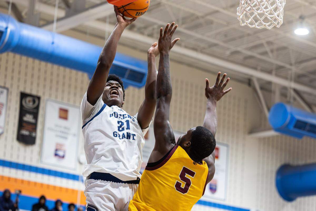 Queen’s Grant Stallions player Chase Smith, left, shoots past the West Charlotte Lions’ Jkhai Wade during the Mike Gminski Classic at Marvin Ridge High School in Waxhaw, North Carolina, on Monday, Dec. 29, 2025.