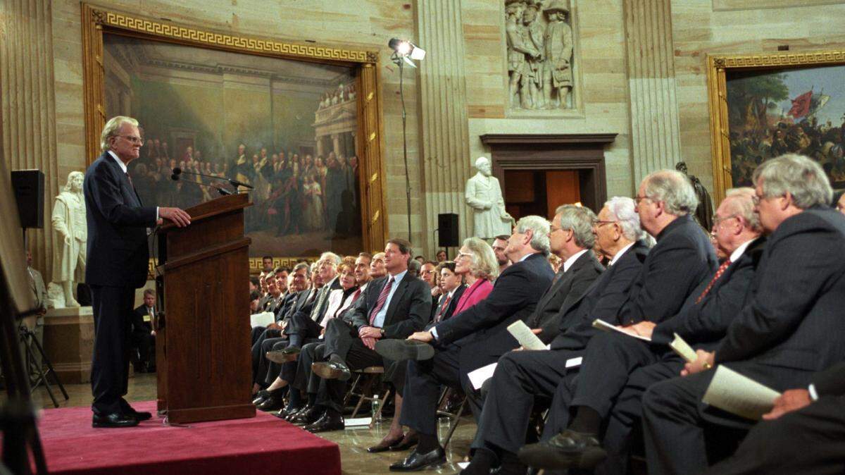Surrounded by the congressional statues, Billy Graham speaks to political leaders at his Congressional Gold Medal ceremony in 1996. The Grahams were the 114th recipients of Congress’ highest civilian honor.