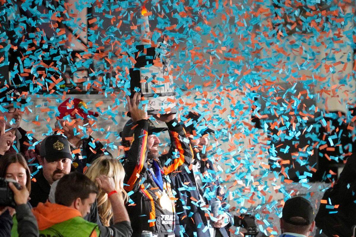 NASCAR Cup Series driver Martin Truex Jr. life his trophy after winning the Busch Light Clash NASCAR exhibition auto race at Los Angeles Memorial Coliseum Sunday, Feb. 5, 2023, in Los Angeles. (AP Photo/Mark J. Terrill)
