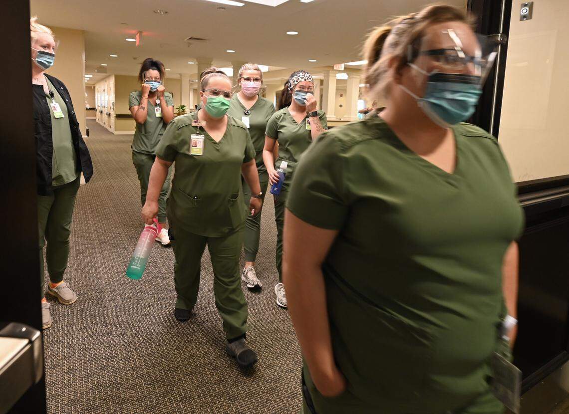 Students who are studying to become CNAs walk through a wing of the Abernethy Laurels nursing home in Newton.
